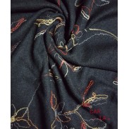 Tejido de lana rizada en negro bordada con hilo de mecha multicolor