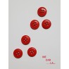 Botón rojo con cuatro agujeros