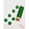 Botón verde con cuatro agujeros